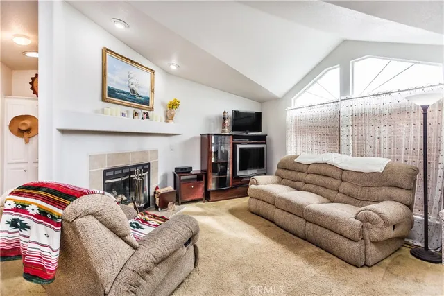 a living room with furniture a fireplace and window