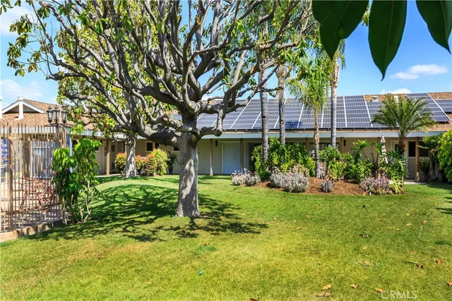 a view of a house with a yard and sitting area