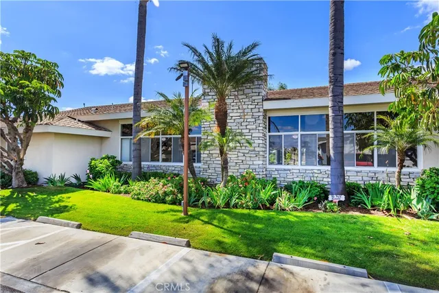 a view of a house with a yard and potted plants