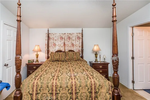 a bedroom with a bed and a lamp