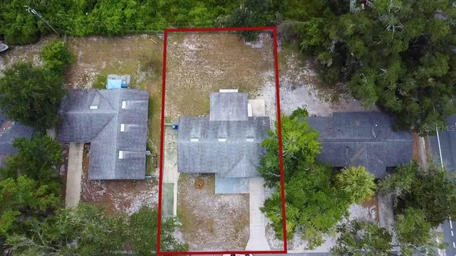 an aerial view of a house with outdoor space and street view