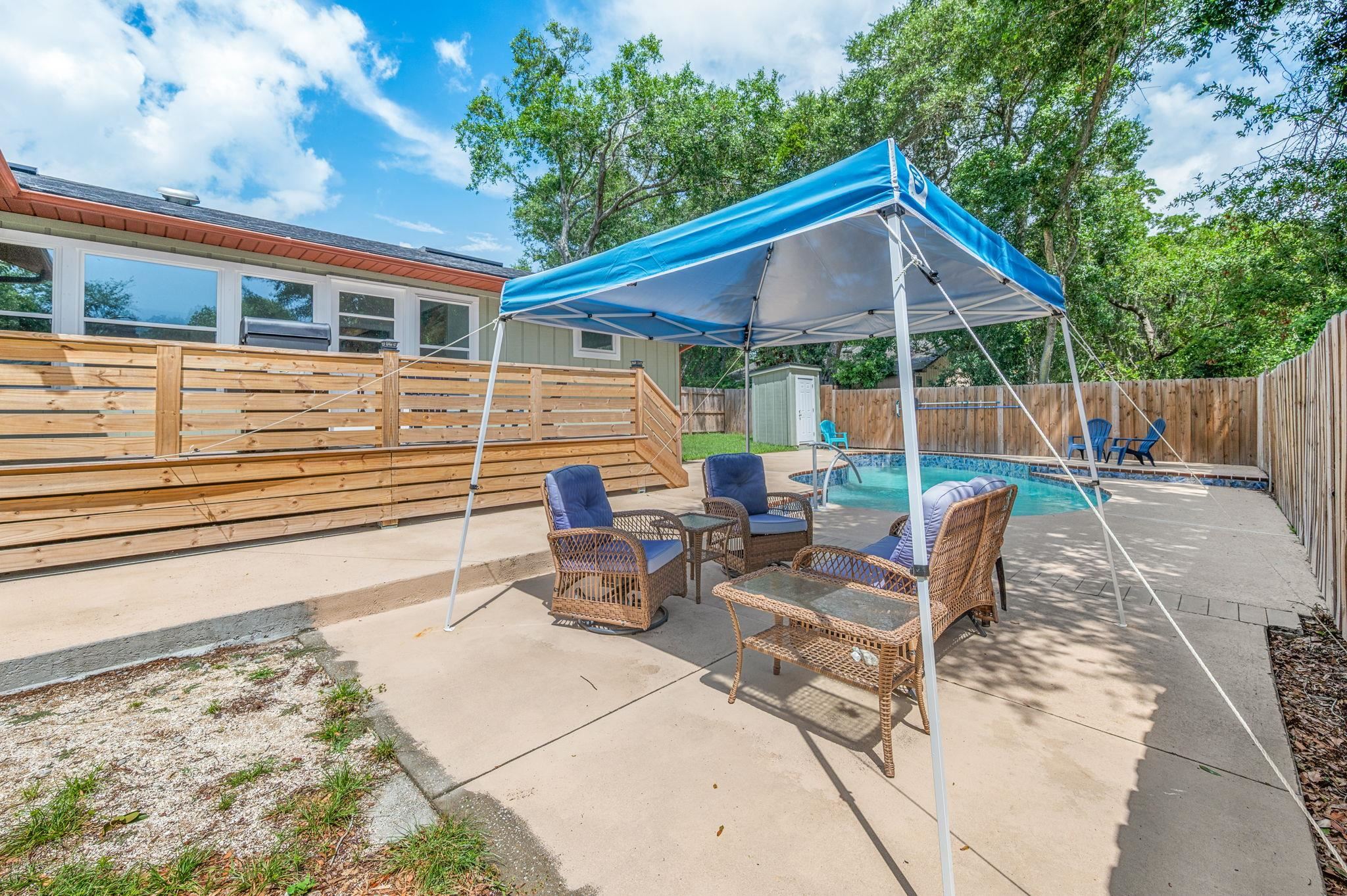 507 Gentian Road St. Augustine, FL 32086 - Photo 44 of 82 a view of a patio with a table and chairs under an umbrella