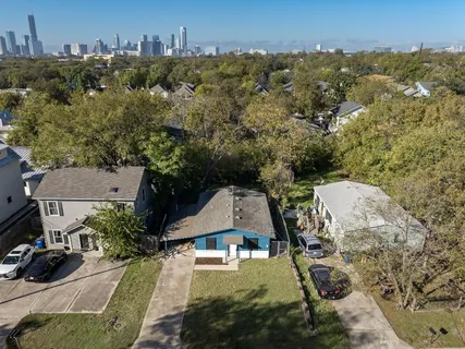 an aerial view of a house with yard