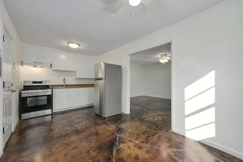a kitchen with a refrigerator and window