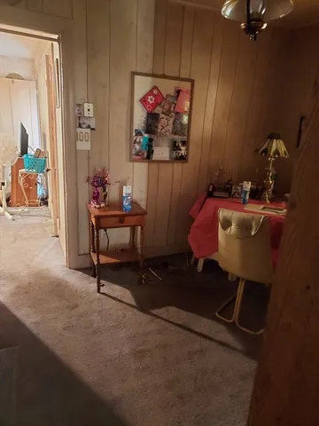 a living room with furniture and a painting on the wall