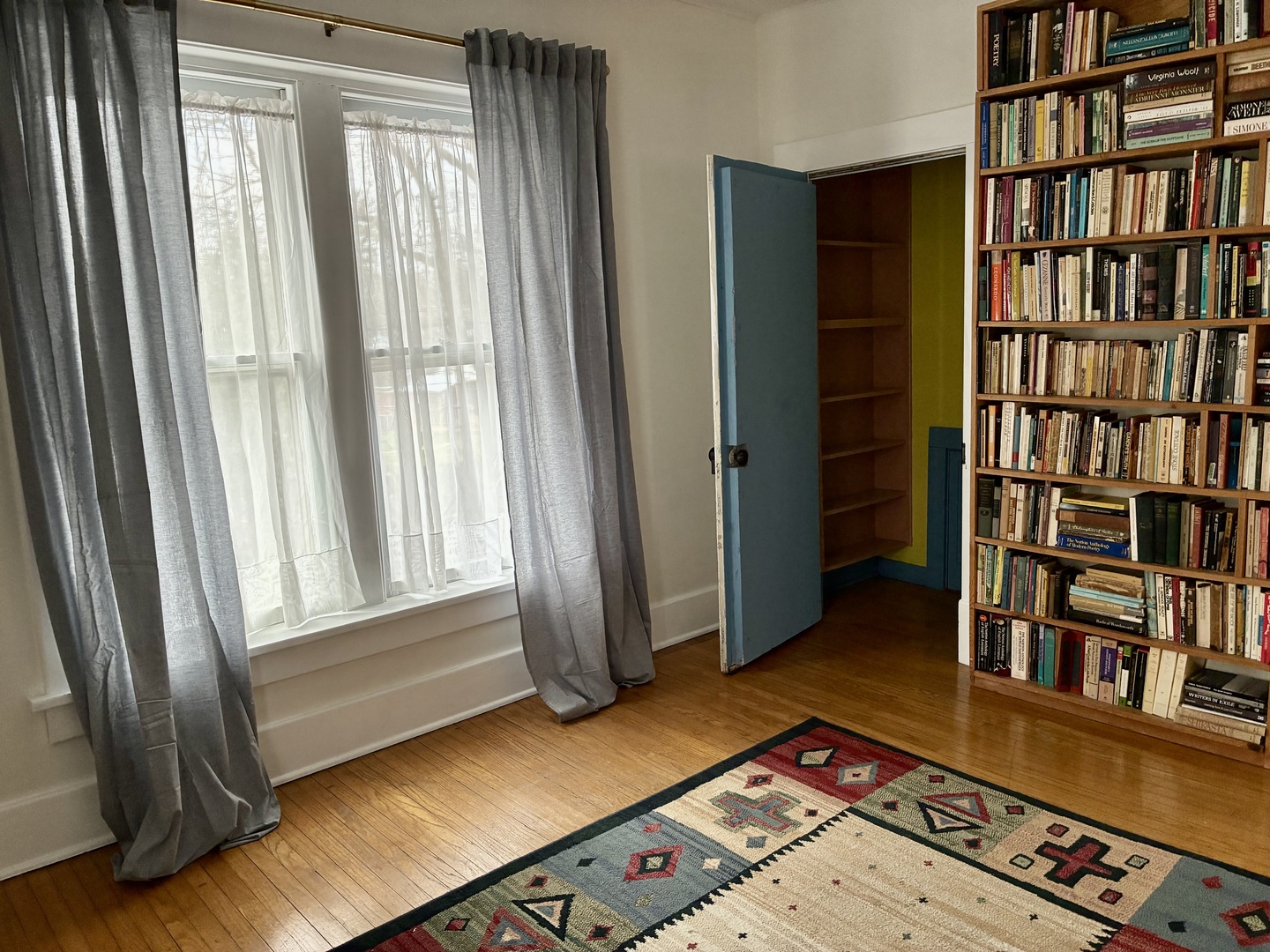 1009 West Church Street Champaign, IL 61821 - Photo 26 of 40 a living room with couch and a book shelf