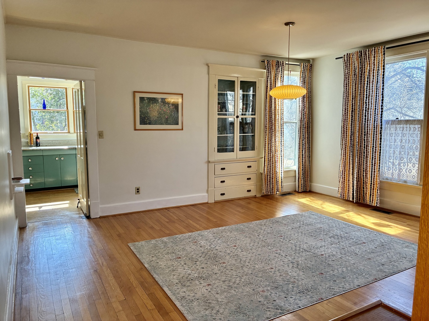 1009 West Church Street Champaign, IL 61821 - Photo 8 of 40 an empty room with wooden floor and windows