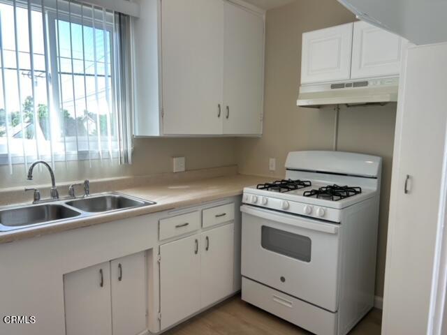 714 West 5th Street, Unit 714D Oxnard, CA 93030 - Photo 4 of 7 a kitchen with cabinets appliances a sink and a window