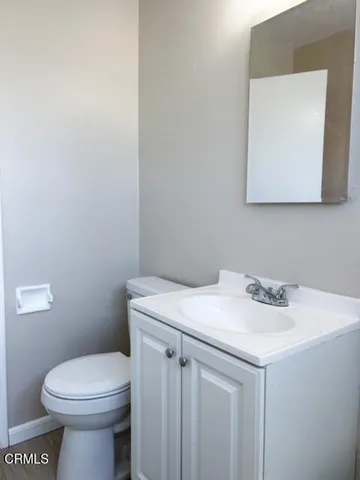 a bathroom with a sink a toilet and mirror