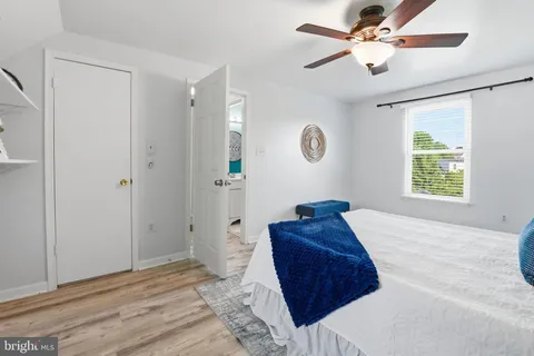 a bedroom with a bed mirror and a window