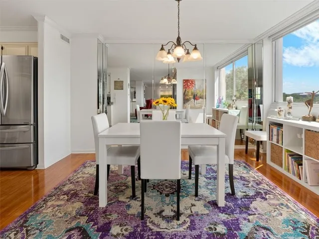 a view of a dining room with furniture window and wooden floor