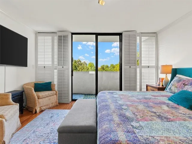 a bedroom with a bed and glass window