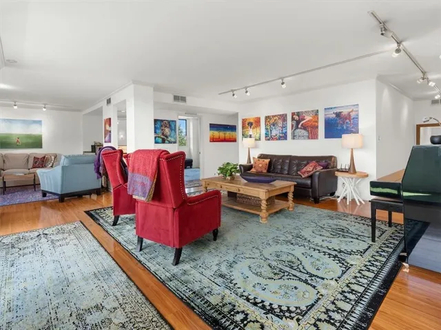 a living room with furniture rug and wooden floor