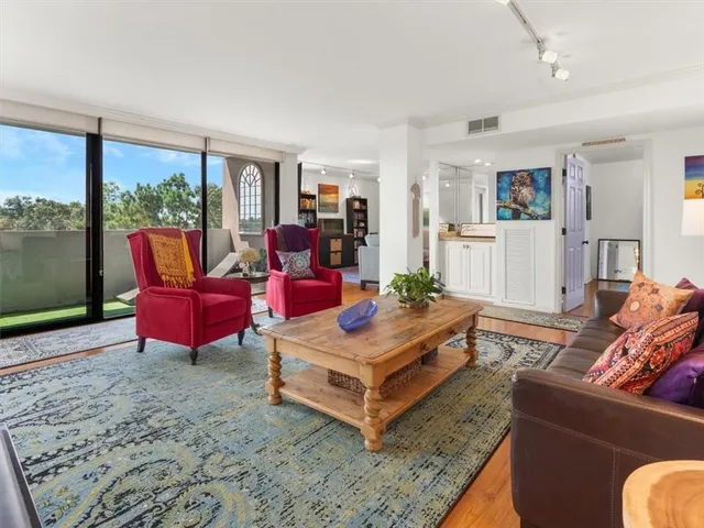 a living room with furniture city view and large windows