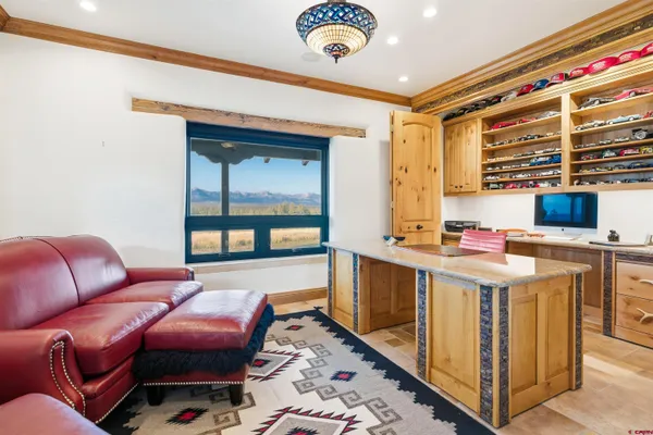 a living room with furniture and a floor to ceiling window