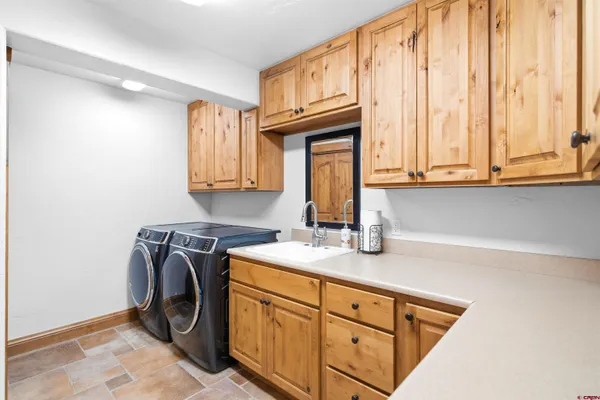 a spacious bathroom with a granite countertop sink a toilet a mirror and bathtub