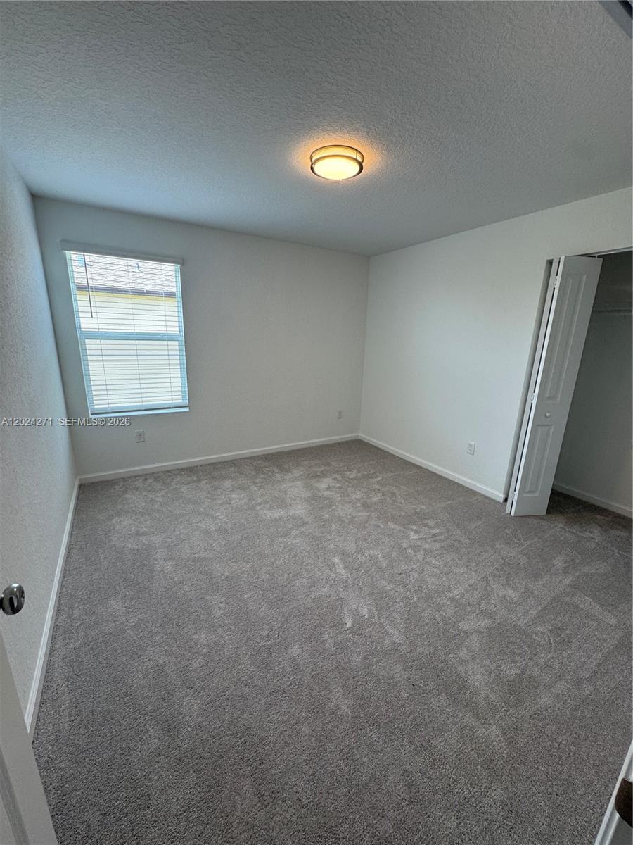 693 Carlyle Way Fort Pierce, FL 34947 - Photo 10 of 19 an empty room with a empty space and window