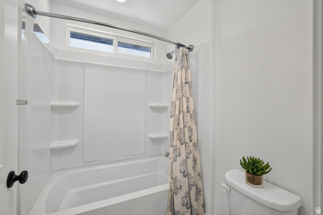 6536 West Muirfield Road Highland, UT 84003 - Photo 21 of 48 White bathtub and shower combination unit featuring an integrated soap dish and shelves