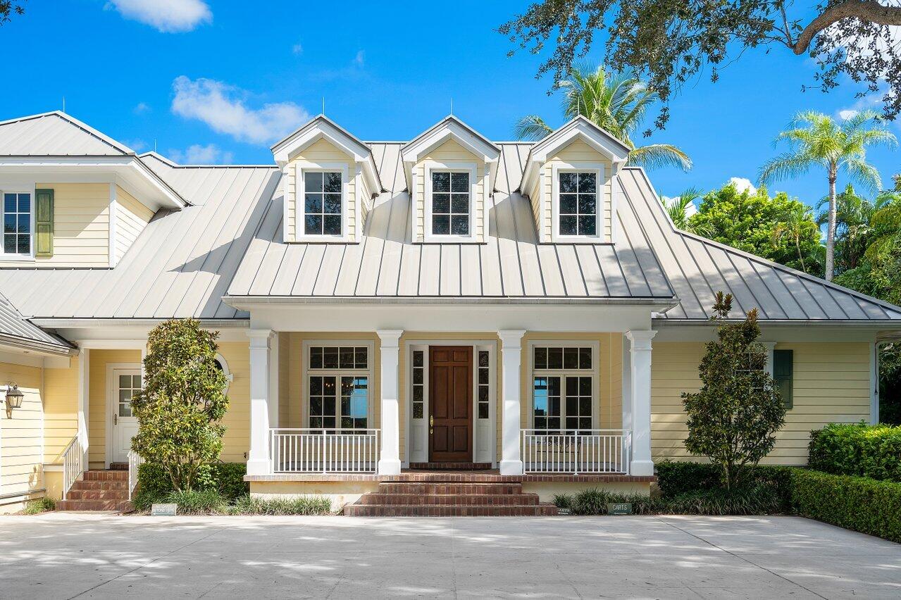 5559 Pennock Point Road Jupiter, FL 33458 - Photo 22 of 72 a front view of a house with a garden