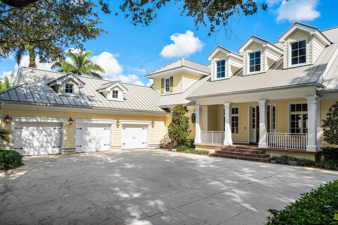 5559 Pennock Point Road Jupiter, FL 33458 - Photo 23 of 72 a front view of a house with a yard