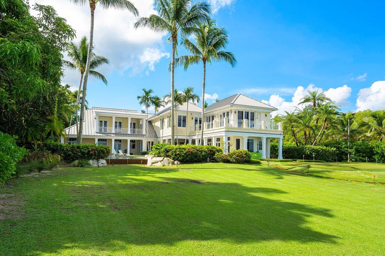 5559 Pennock Point Road Jupiter, FL 33458 - Photo 56 of 72 a front view of a house with a garden