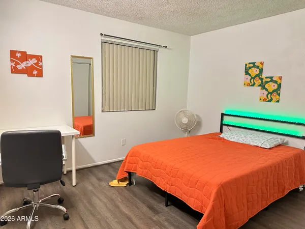 a blue bed sitting in a bedroom next to a window
