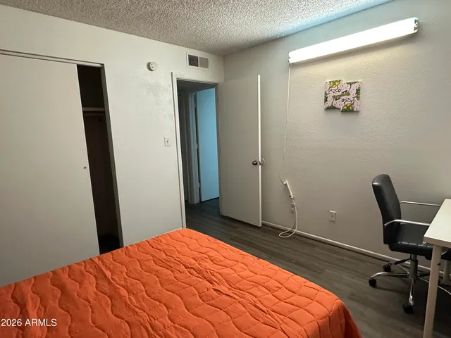 a bedroom with a bed and a desk