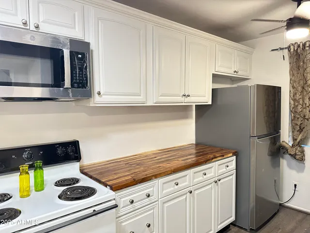 a kitchen with appliances and cabinets