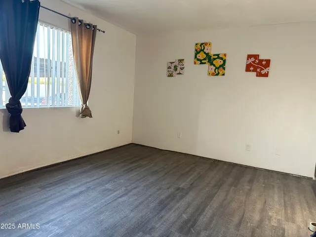 a view of room with window and hardwood floor