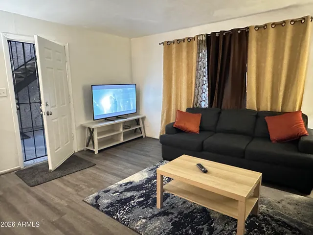 a living room with furniture and a rug