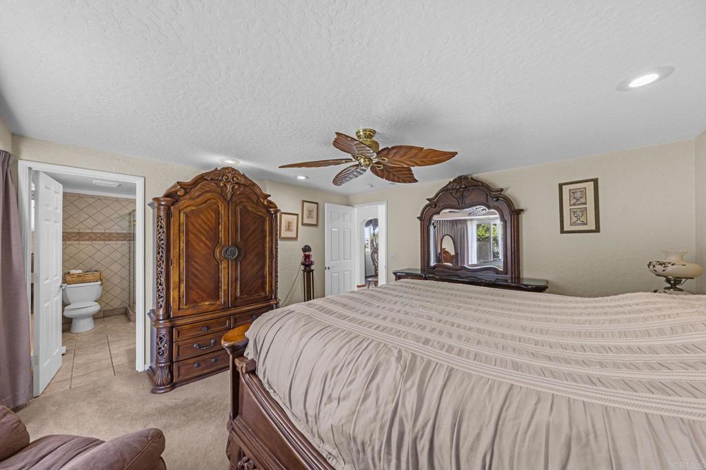 30265 Miller Road Valley Center, CA 92082 - Photo 21 of 56 a bedroom with a bed and a mirror