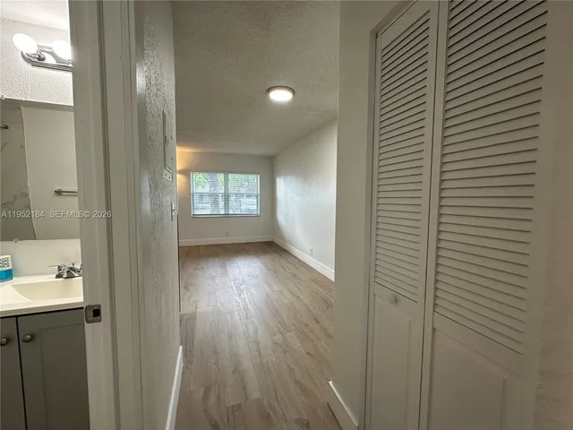 a view of a hallway view with wooden floor and staircase