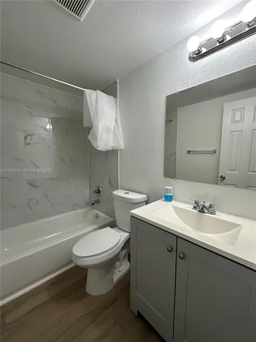 a bathroom with a sink a toilet and a bathtub