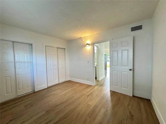 a view of hallway with wooden floor