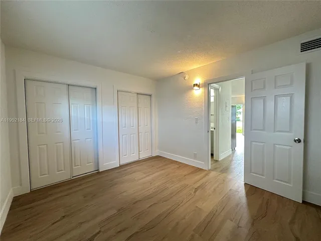 a view of an empty room and wooden floor
