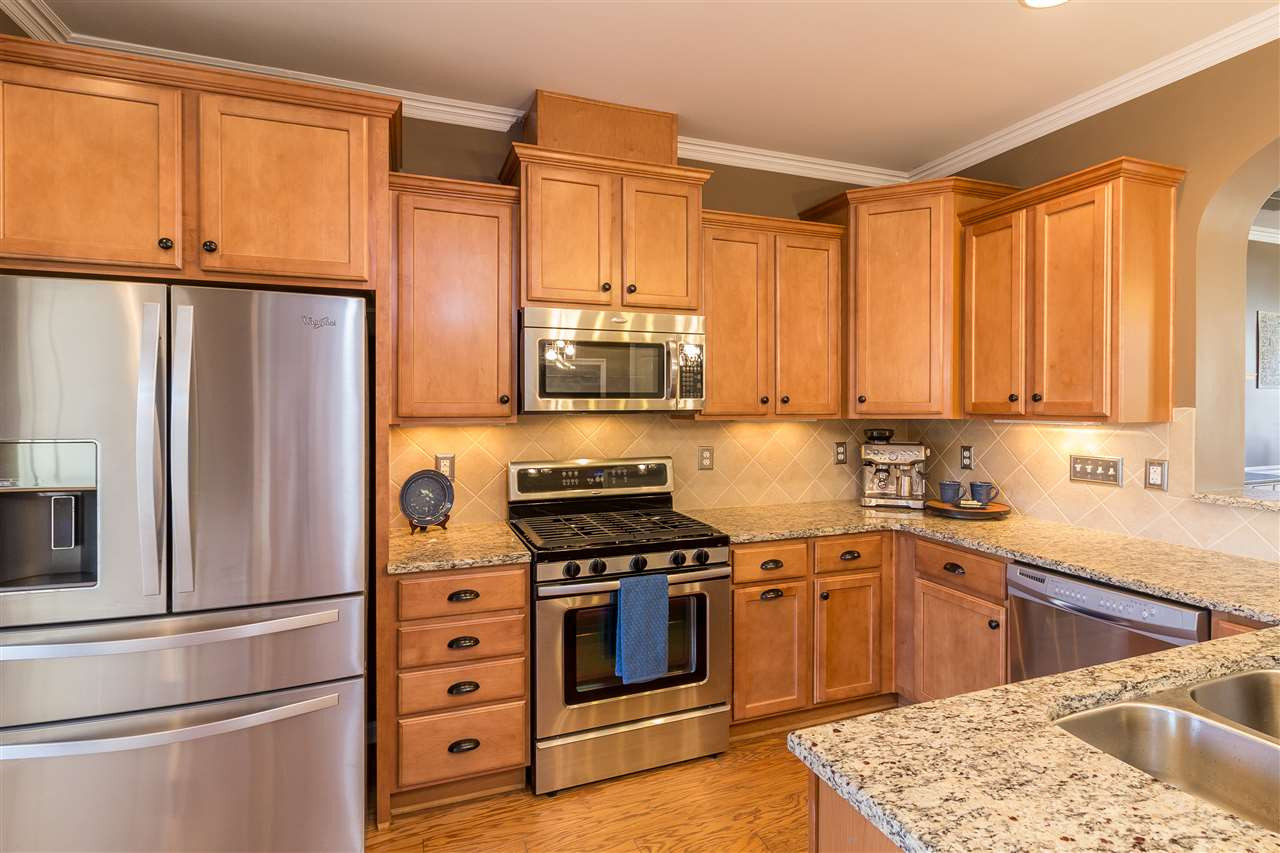 9135 Falkwood Road Raleigh, NC 27617 - Photo 9 of 25 Chef's kitchen features stainless gas stove, microwave, dishwasher, and a double sink with newer whisper quiet disposal. Two year old French door refrigerator also included! Kitchen