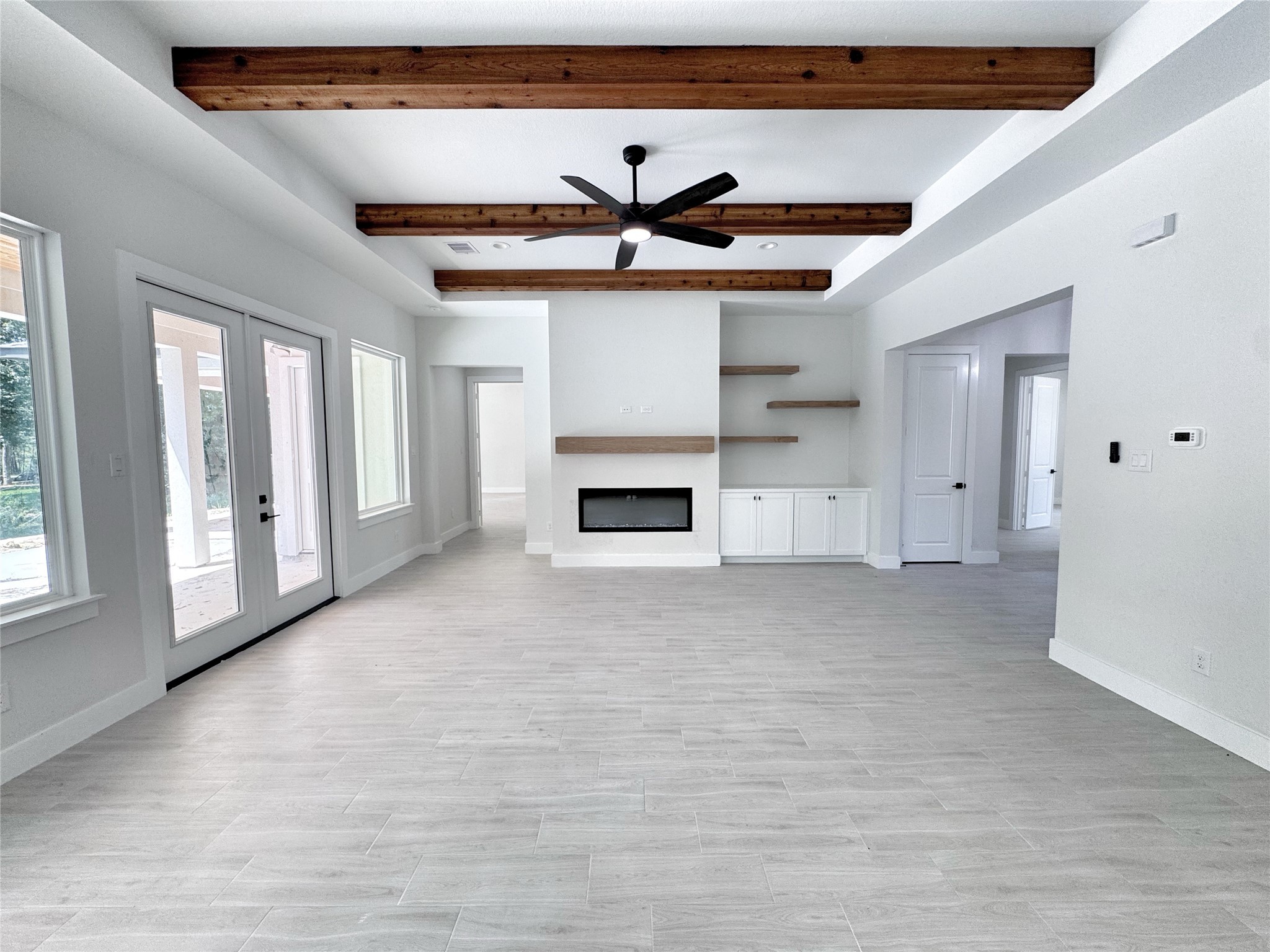 27710 Colapis Drive Splendora, TX 77372 - Photo 12 of 49 a view of an empty room with a fireplace and a window