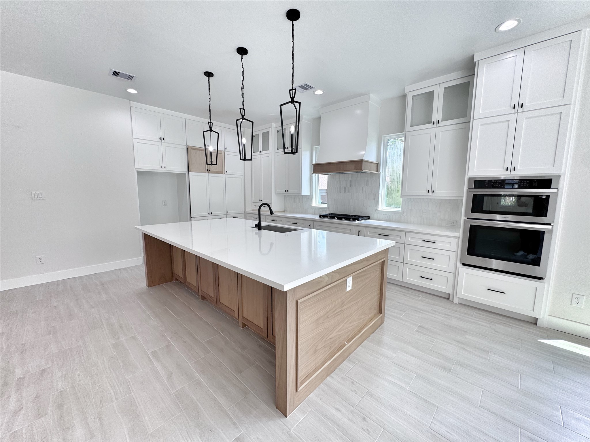 27710 Colapis Drive Splendora, TX 77372 - Photo 13 of 49 a kitchen with stainless steel appliances sink stove and cabinets