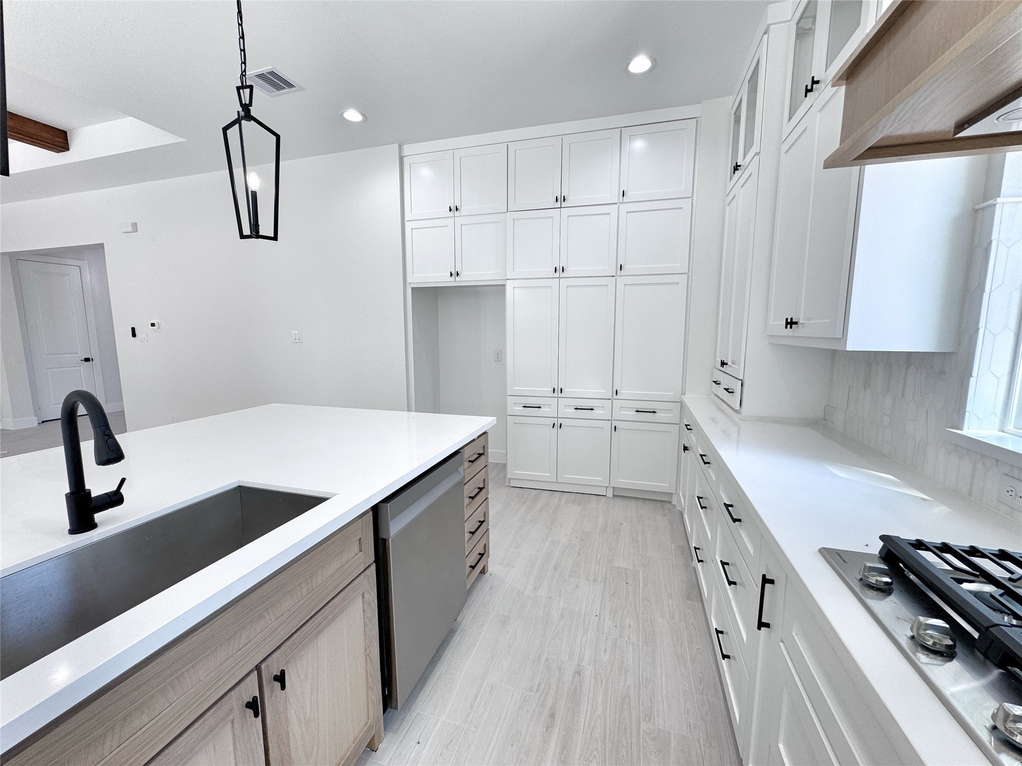 27710 Colapis Drive Splendora, TX 77372 - Photo 14 of 49 a kitchen with a sink stove and white cabinets