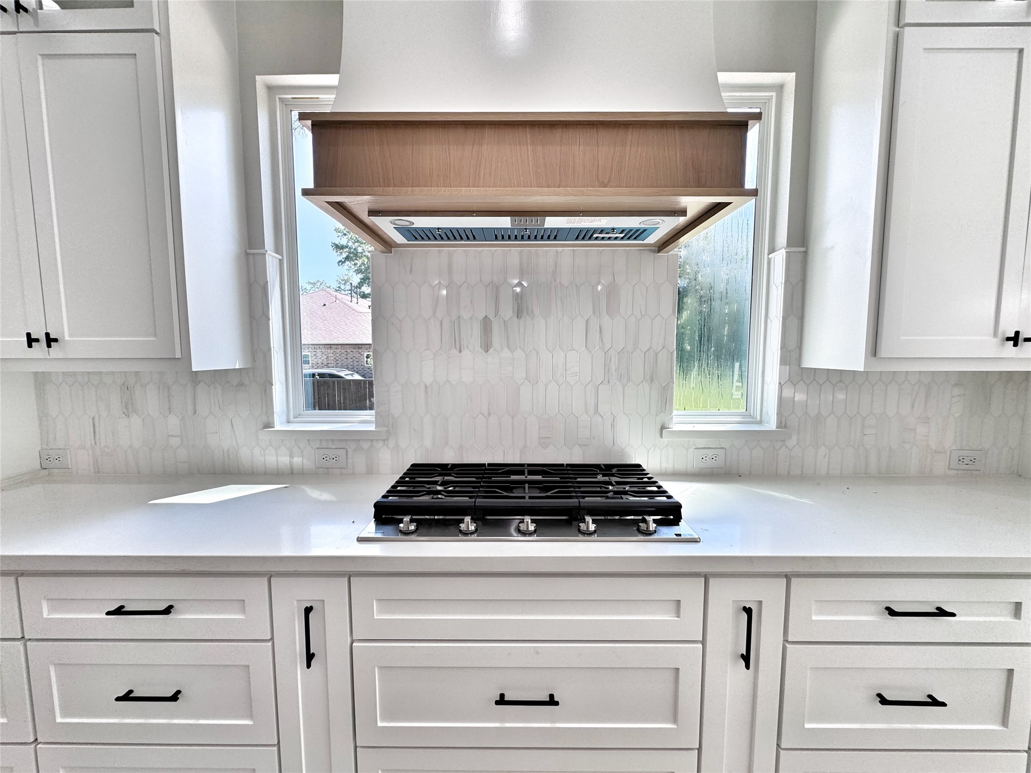 27710 Colapis Drive Splendora, TX 77372 - Photo 16 of 49 a kitchen with a stove and white cabinets