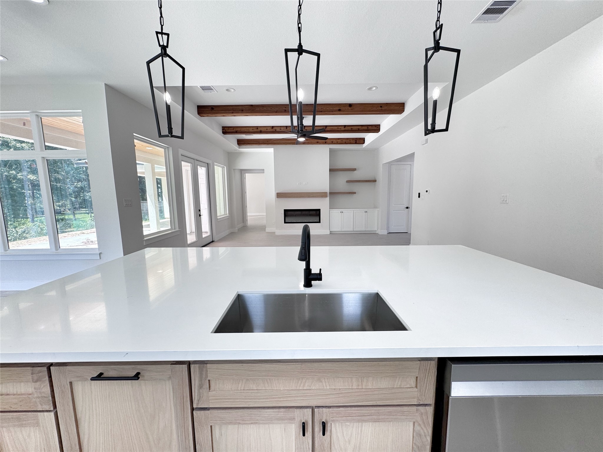 27710 Colapis Drive Splendora, TX 77372 - Photo 17 of 49 a kitchen with a sink a chandelier and wooden floor