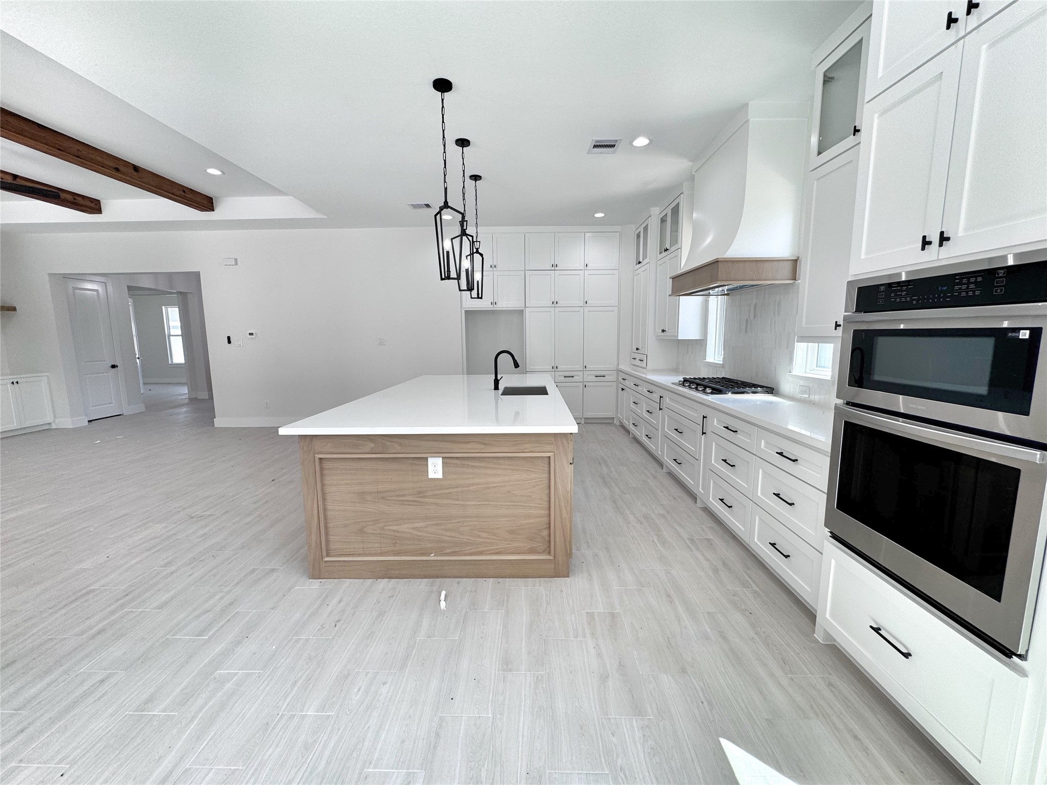 27710 Colapis Drive Splendora, TX 77372 - Photo 18 of 49 a kitchen with stainless steel appliances a stove a sink and a refrigerator