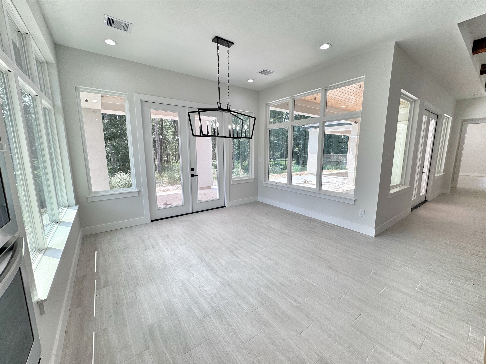 27710 Colapis Drive Splendora, TX 77372 - Photo 20 of 49 a view of an empty room with a window and wooden floor