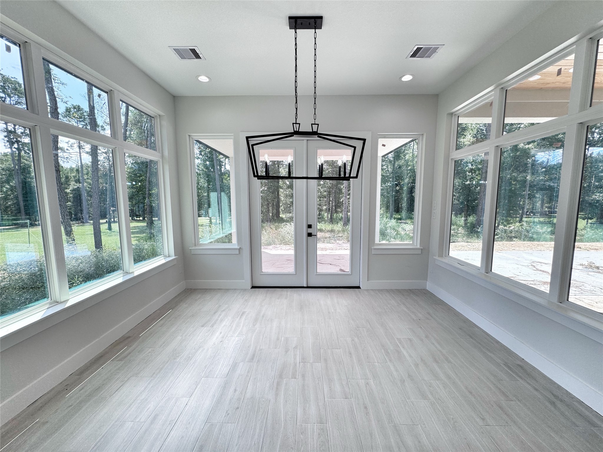 27710 Colapis Drive Splendora, TX 77372 - Photo 21 of 49 a view of an empty room with glass door and windows