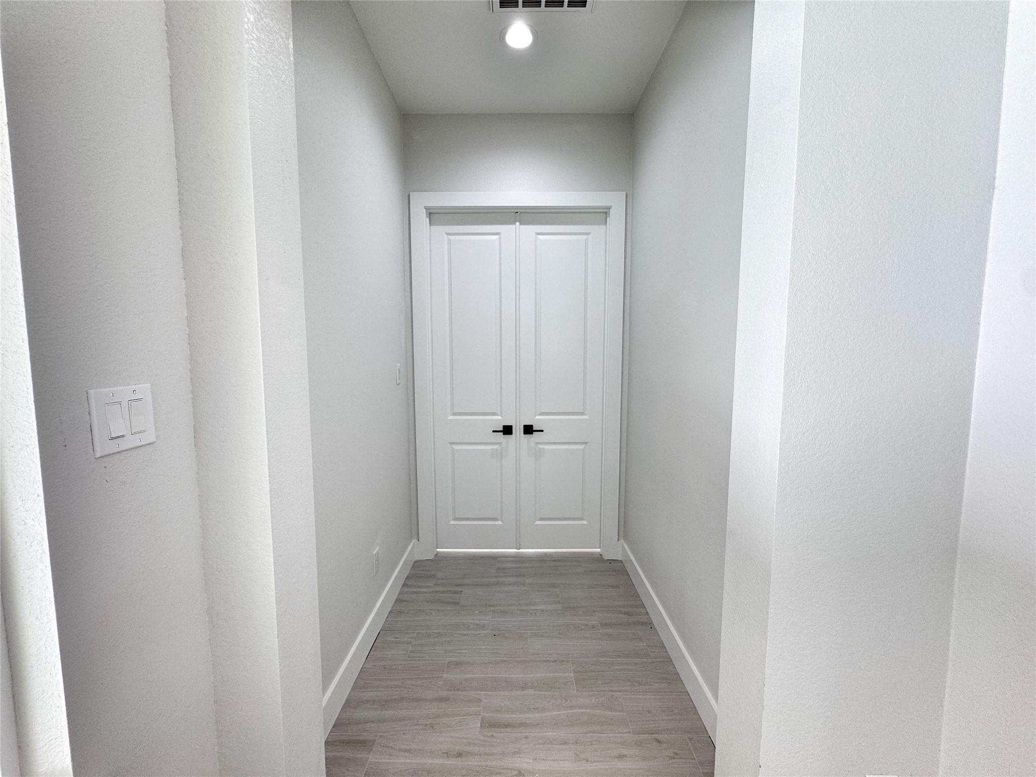 27710 Colapis Drive Splendora, TX 77372 - Photo 23 of 49 a view of a hallway with wooden floor