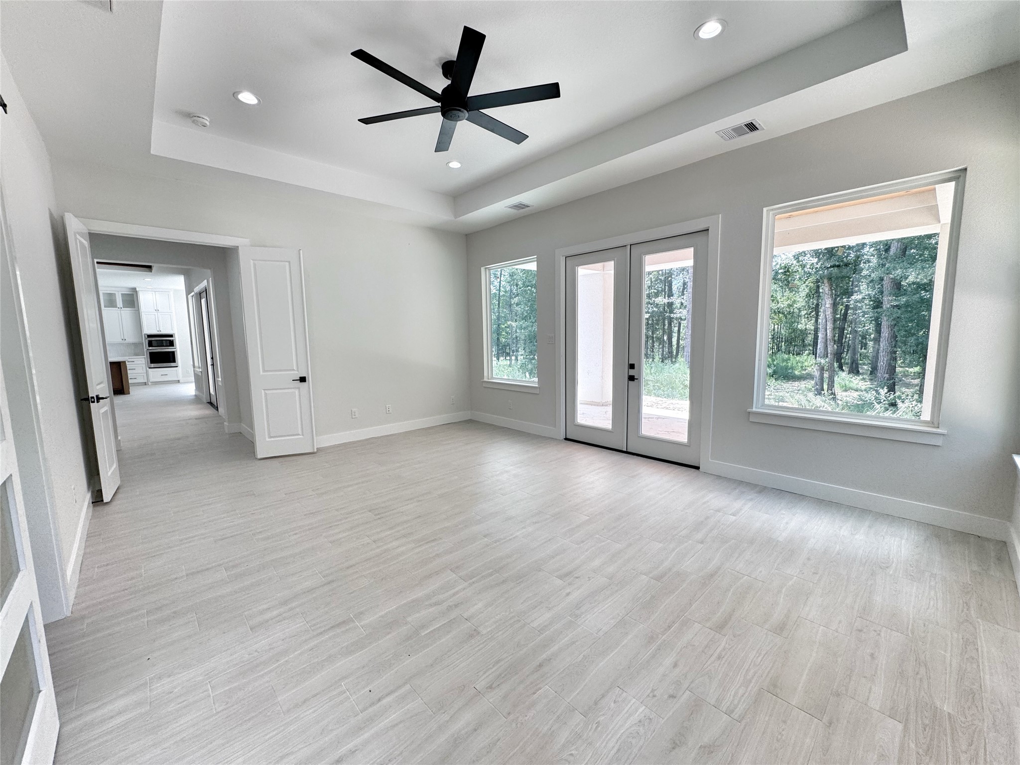 27710 Colapis Drive Splendora, TX 77372 - Photo 27 of 49 a view of an empty room with a window and wooden floor