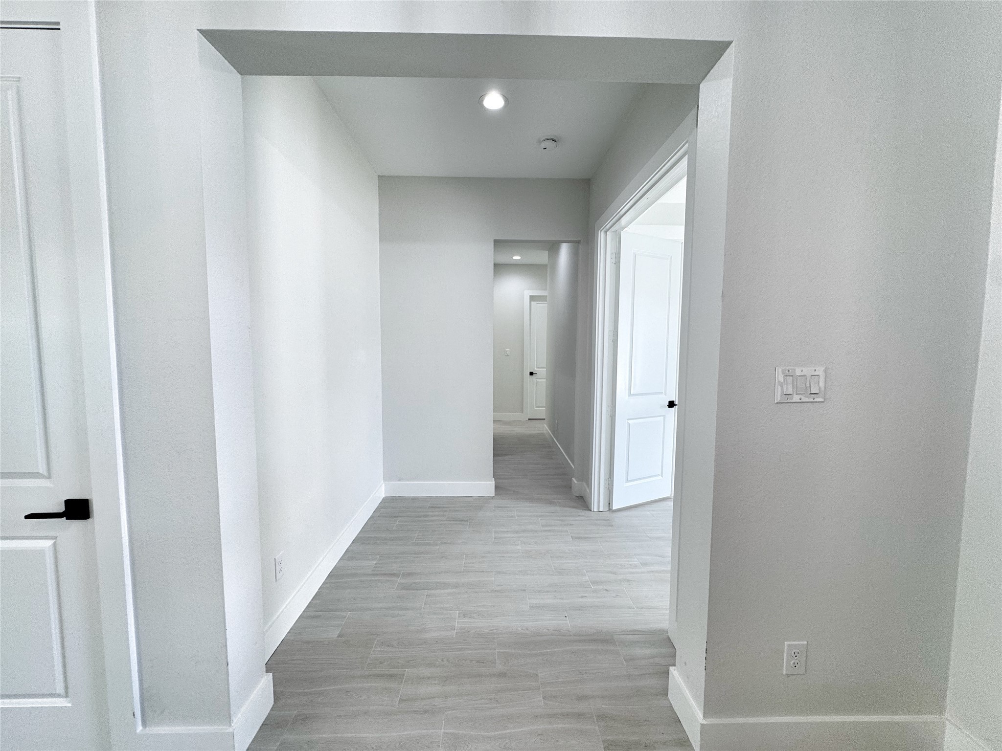 27710 Colapis Drive Splendora, TX 77372 - Photo 33 of 49 a view of a hallway with wooden floor