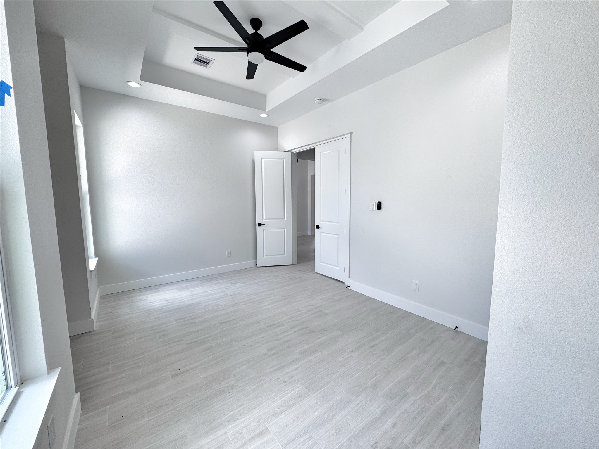27710 Colapis Drive Splendora, TX 77372 - Photo 36 of 49 an empty room with wooden floor and windows