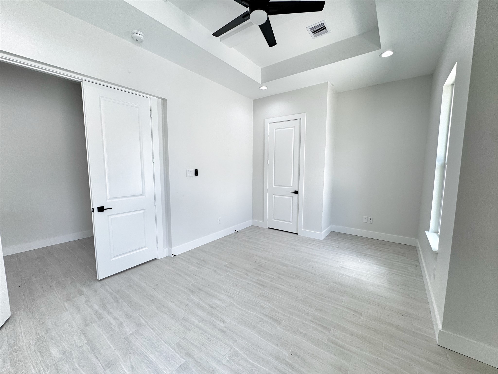 27710 Colapis Drive Splendora, TX 77372 - Photo 37 of 49 an empty room with wooden floor and windows