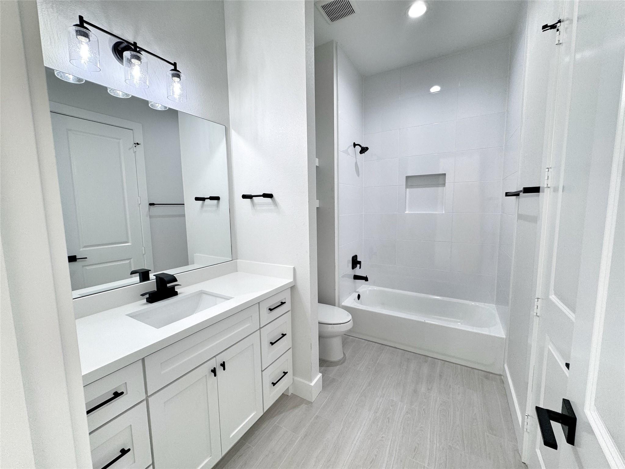 27710 Colapis Drive Splendora, TX 77372 - Photo 41 of 49 a bathroom with a double vanity sink toilet mirror and bathtub